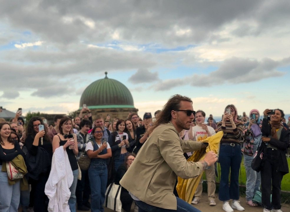 Hundreds gather on Edinburgh's Calton Hill to watch man fold bed sheet