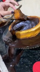 Chocolate Spills as Person Tries to Pull Out Piece of Cake