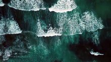 Beautiful texture of big power dark ocean waves with white wash. Aerial top view footage of fabulous sea tide on a stormy day. Drone filming breaking surf with foam in Caribbean Sea
