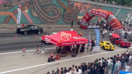 Moldova drag racing event turns chaotic when car hits curb and flips under bridge