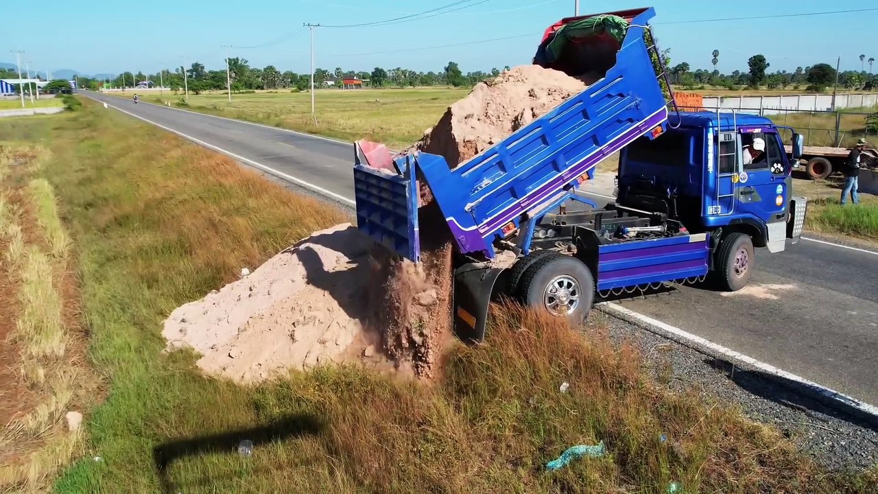 Drivers passing by must be very careful. when there is a pour soil truck working near the highway