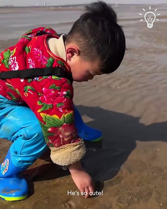 Little boy catching fish by hand!
