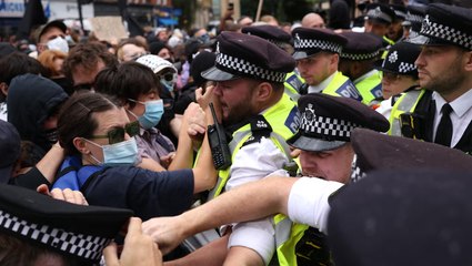 Police scuffle with protesters outside hotel housing immigrants