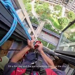 This air conditioner technician is working way above the ground!