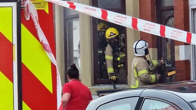 Firefighter breaks down door to tackle blaze as street is closed off