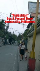 Pedestrian on Gov. Pascual Street in Navotas City in the Philippines