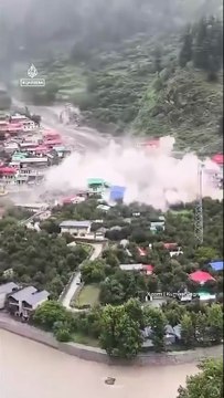 Flash flooding caused by a massive cloudburst was filmed wiping out buildings in a Himalayan town in India on Tuesday, as rescuers fear dozens are trapped.