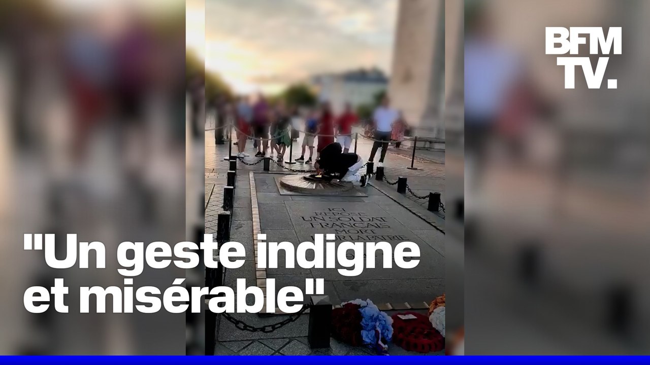 Un homme allume sa cigarette avec la flamme de la tombe du Soldat inconnu