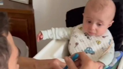 Baby tries first spoon of food and pulls a hilariously dramatic face