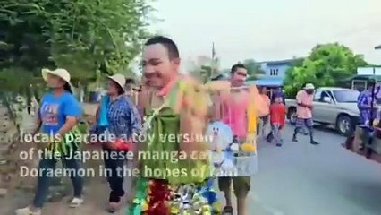 A rain-making ceremony held in Thailand_ which used a Doraemon plush toy