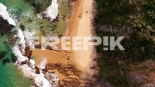 aerial of scarborough beach, nsw, australia, with golden sand, turquoise waters, and rocky cliffs, establishing top down ascend nature backdrop