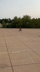 Kid Rides Behind Truck, Falls Midway as Only Bike Emerges From Other Side