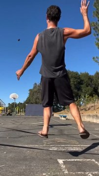 Man Hoops Rugby Ball While Balancing on Slackline