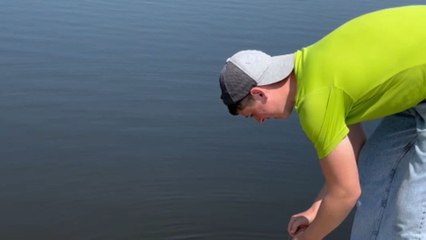 Catch of the day almost lost when fish bag falls into water but quick-thinking man saves it
