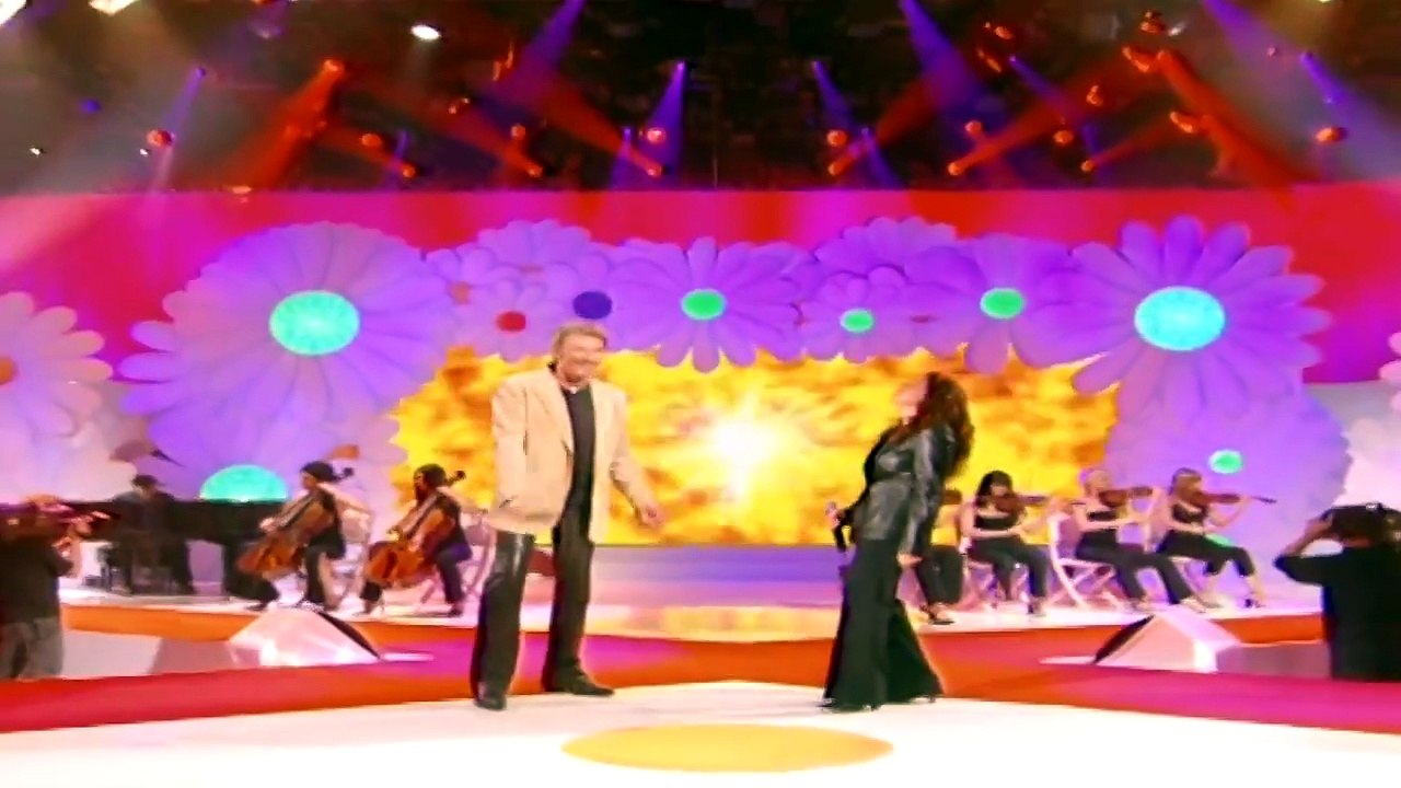 Johnny Hallyday et Isabelle Boulay — “Vivre pour le meilleur” — Johnny Hallyday et Isabelle Boulay (L. Florence / D. Hallyday) | Chantons ensemble contre le Sida — © 2004 TF1 VIDEO