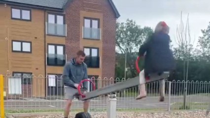Man joins little girl on seesaw and ends up ripping his shorts