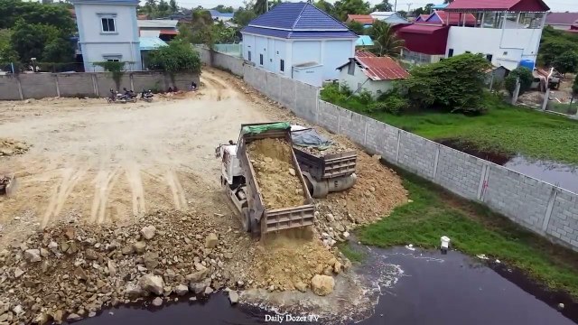 Dump Truck 5T Starting unloading Soil Stone and Bulldozer Pushing it into water Filling Long Lake