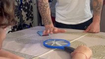 Boy taps bug zapper and receives a mini electric jolt on his finger