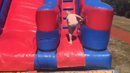 Little boy misjudges bouncy slide and ends with a faceplant