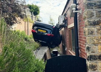 Staff shocked after car flips upside down and crashes through gym window