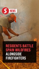 Residents battle wildfires alongside firefighters in Spain