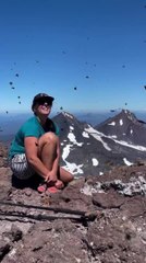 Hundreds of Butterflies Surround Woman on Top of Mountain Peak