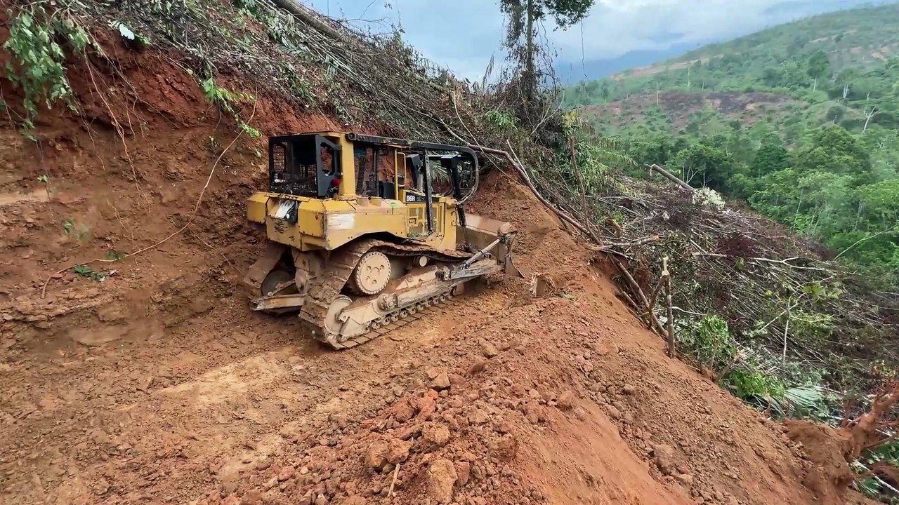 Bulldozer D6R XL Creates a Path in Extreme Mountain Slope Terrain