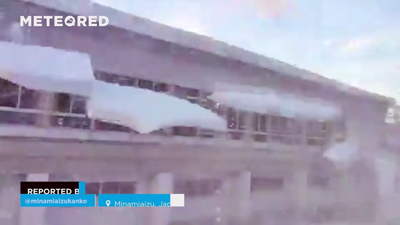 Large blocks of snow  fall from a rooftop in Minamiaizu, Japan
