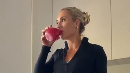 Girl sips preworkout drink and ends up breaking her glass