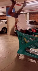 Man Falls and Breaks Shopping Cart While Attempting Handstand