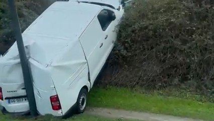 Confusing post-crash scene features van sandwiched in a nearly impossible position