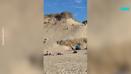 Man Rolls Down Sand Dunes