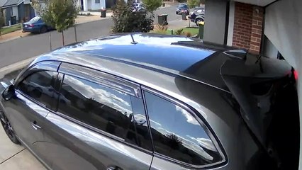 Car Accidentally Reverses Into Partially Open Garage Door