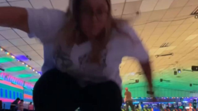 Roller-skater loses balance while setting up camera and takes funny tumble on rink