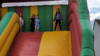 Little boy almost falls hard after bouncing wildly on inflatable slide