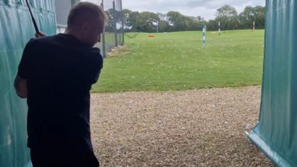 Man swings golf club and hits the tee instead of the ball