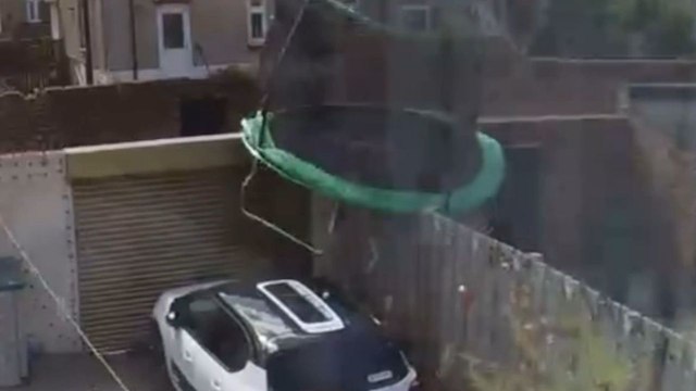 Strong winds of Storm Floris lift trampoline into the air before it nearly strikes a parked car