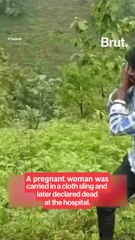 A tribal pregnant woman carried on a cloth stretcher