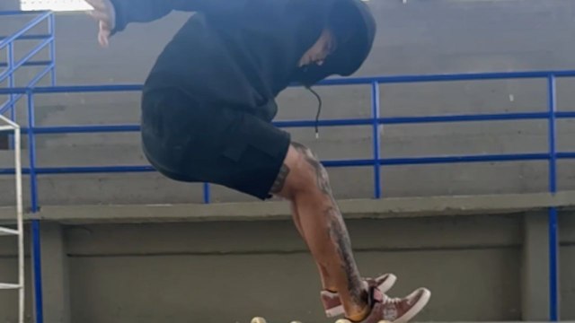 Skater fumbles the landing while trying a kick-flip and falls onto the floor