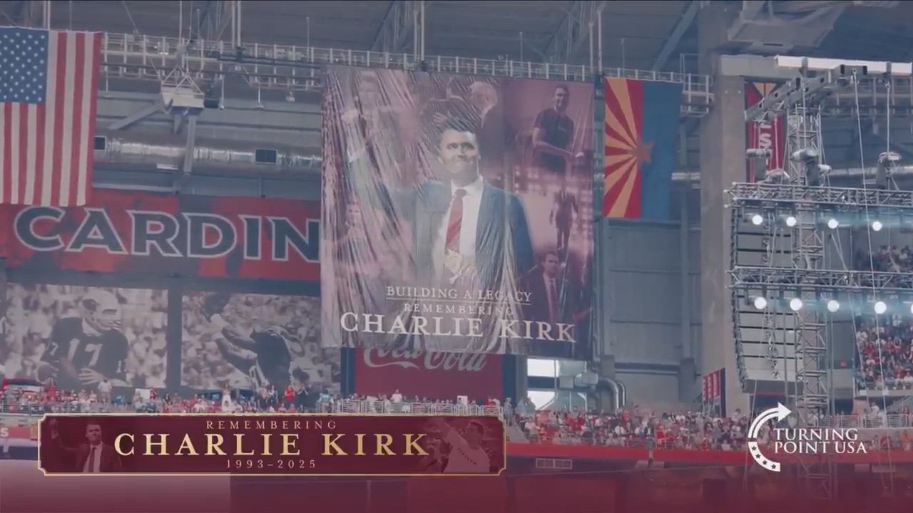 Entire State Farm Stadium Gives Standing Ovation as Charlie Kirk Tribute Banner Appears.