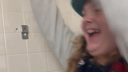 Boy swings on a locker room crossbar and ends in a hard fail