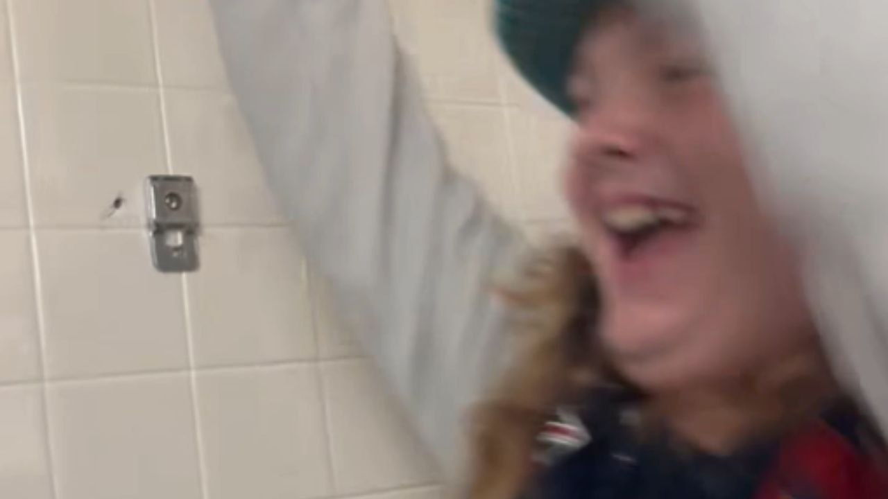 Boy swings on a locker room crossbar and ends in a hard fail