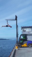 Man Performs Front Lever Hanging Using Forklift Over Water