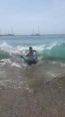 Man's Face Gets Covered in Sand After Wave Knocks Him Over