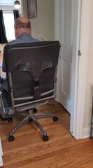 Man on Chair Gets Pulled Around by Dog While Playing Tug of War