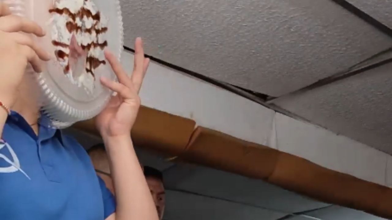 Camera captures woman licking cake from lid and her comical reaction when she realizes it
