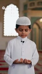 A little boy in Islamic dress. saying Bismillah