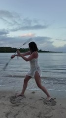 Woman Shows off Nunchuck Skills on Beach