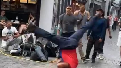 Boy balances on his head and spins with the perfect rhythm