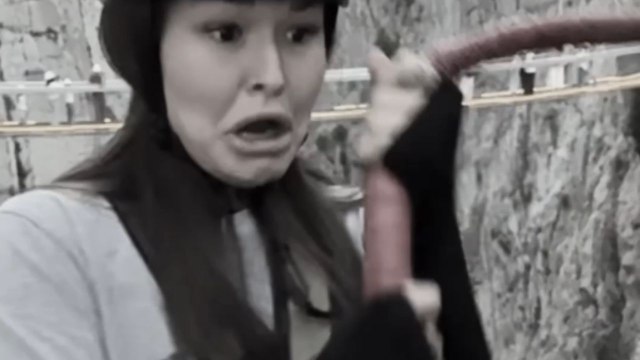 Girl stands frozen on platform until team pushes her into bungee jump